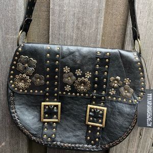 Black leather handbag with brass like flowers